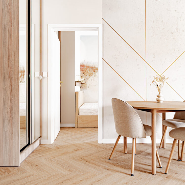 Okrągły stół jadalny w centralnym punkcie mieszkania łączy salon z sypialnią, wprowadzając otwartą przestrzeń.